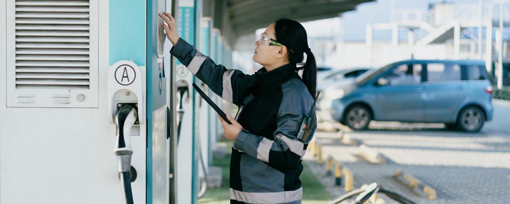 EV Technician servicing charging station